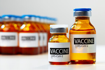 Sars-cov-2 vaccine vial bottles on white table