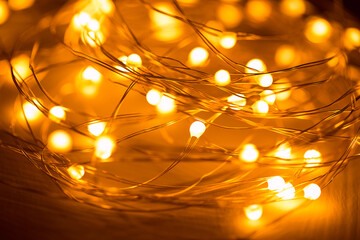 Yellow led garland on a wire close-up. Christmas lighting for decorating your home for Christmas.