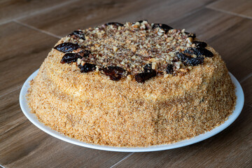 Delicious cake with prunes and sprinkled grated nuts. Home baked