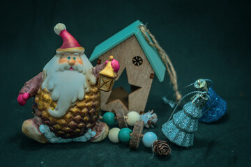 Christmas Santa next to the toy house .