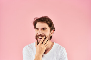 Bearded man white t-shirt cropped view lifestyle studio pink background