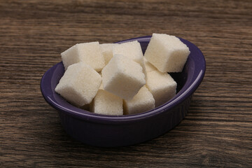 Refined white sugar cubs in the bowl