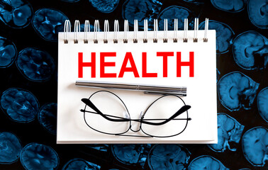 Text HEALTH on a mri background. Nearby are various medicines. Medical concept.
