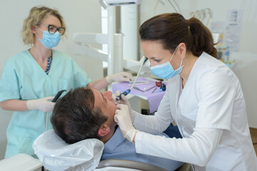 dentists with a patient during a dental intervention