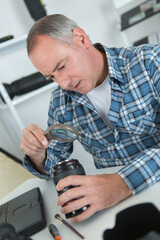 a professional photographer cleaning lens