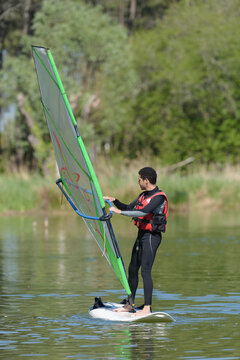 a man is windsurfing on a lake