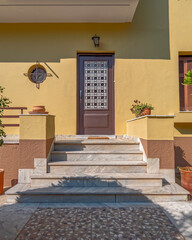 stylish traditional family house facade with marble stairs to the main entrance door, Athens Greece