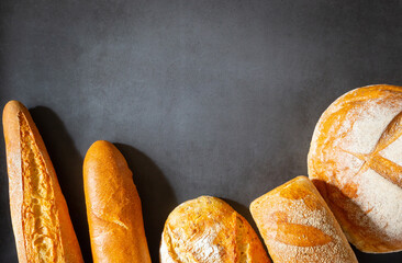 Different types of loaves of artisan bread close-up with copy space space for text