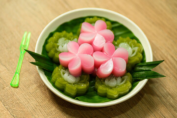Layered candy Thai dessert rose shape on wooden table
