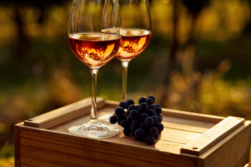 Close up of two glasses of rose wine on a wooden crate
