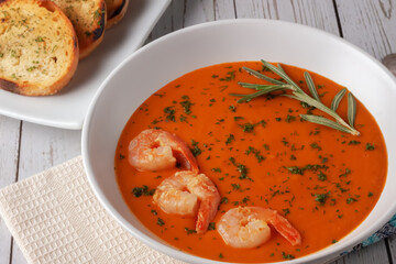 Bean puree soup with tomatoes, shrimps and rosemary. Diet food.