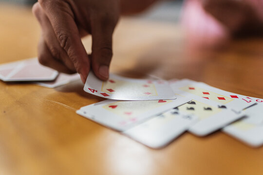 Happy Latin American Family Playing Cards At Home. Young People Having Fun And Laughing Playing Cards In The Living Room In Home