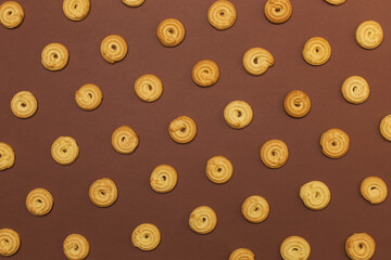 Butter biscuits on brown background