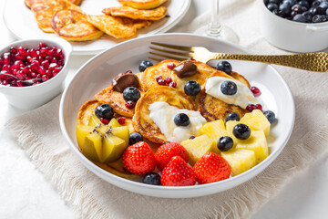 Homemade low calarie curd cheese pancakes with fruit salad