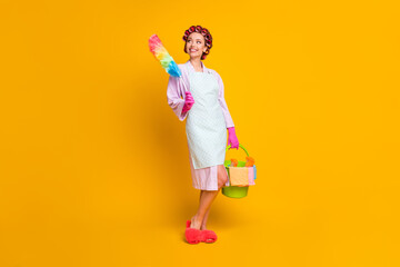 Full length photo of positive girl hold bucket duster wear bath robe gloves isolated shine color...