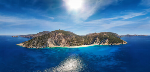 Fototapeta na wymiar Wide aerial panoramic view to the popular beach of Myrtos on the Ionian island of Kefalonia, Greece, with turquoise sea and sunshine during summer time