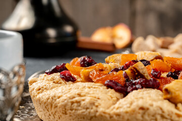 Halva with dried fruits on arabic dishware
