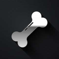 Silver Dog bone icon isolated on black background. Pets food symbol. Long shadow style. Vector.