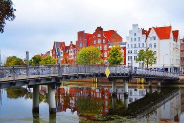 Obraz premium View of the embankment of Ilmenau river with old historical houses in traditional German architecture style. Luneburg city. 
