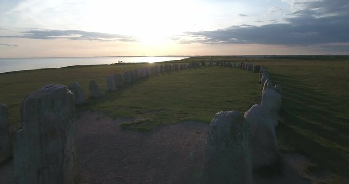 Ancient Oval Formed Rocks Ales Stenar At The Summer Evening Sunset, In South Sweden Sk&aring;ne &Ouml;sterlen K&aring;seberga, Aerial Low Forward