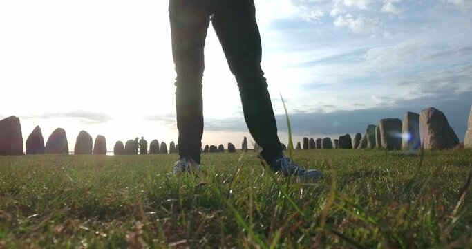 Male Legs WIth Black Jeans and Converse Standing In Front of Ales Stenar at Sunset in the Summer, South Sweden Skåne Österlen Kåseberga, Static