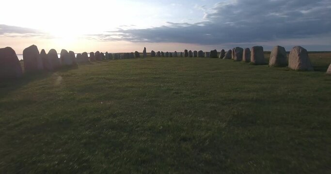 Through Ancient Oval Formed Stones Ales Stenar By The Sunset in South Sweden Sk&aring;ne &Ouml;sterlen K&aring;seberga, Aerial Very Low, Close To Ground Forward