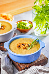  Plate of homemade mushroom cream soup on the table, vertical photo