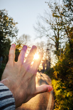 hands and sun. Sunset in nature near Rome Italy. Lanuvio