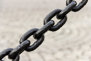 Black painted metal chain in a fence.