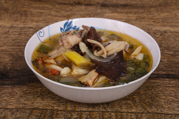 Thai style soup with meat and mushrooms
