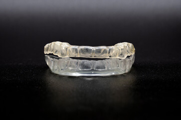 Splint dental night guard with black background.