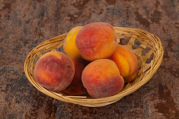 Peach heap in the wooden basket