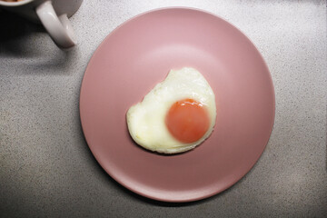 Ascetic diet Breakfast. Fried eggs on a pink plate