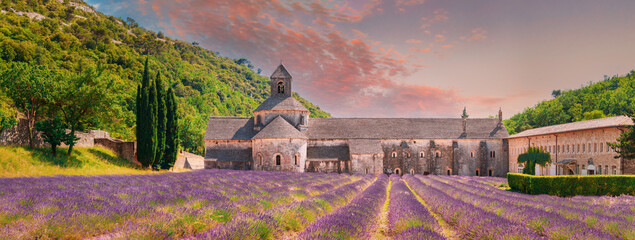 Notre-dame De Senanque Abbey, Vaucluse, France. Beautiful Landscape Lavender Field And An Ancient Monastery Abbaye Notre-dame De Senanque. Elevated View, Panorama. Altered Sunset Sky