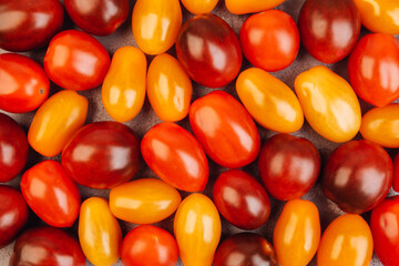 Cherry tomatoes on gray marble background.