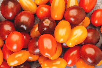 Cherry tomatoes on gray marble background.