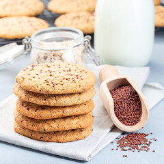 Healthy oatmeal and red quinoa cookies on a table, served with milk, closeup, square