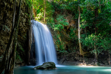 Fototapeta premium Erawan waterfall in Thailand. Beautiful waterfall with emerald pool in nature.