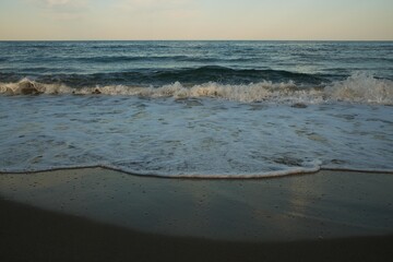 Sea beach with blue sky and yellow sand and some clouds