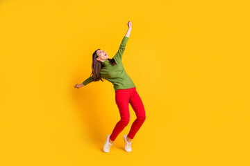 Fototapeta na wymiar Full length body size view of attractive overjoyed cheerful girl jumping dancing having fun isolated bright yellow color background