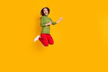 Fototapeta na wymiar Full size photo of funny lady jump upshow novelty empty space wear casual pullover trousers isolated yellow color background