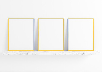 Three vertical gold frame mockups. Gold frame poster on a marble shelf and clean white wall
