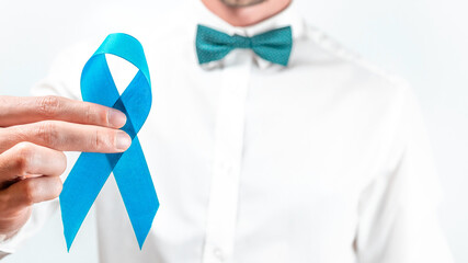 Blue prostate ribbon. Awareness cancer of men health. Hipster men in bright shirt, cyan bowtie with...