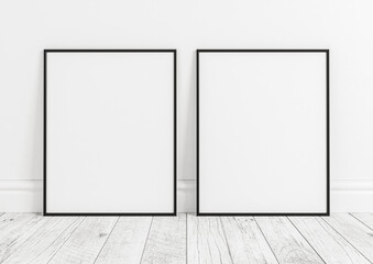 Two vertical black frame mockups. Black frame poster on clean white wall and white wooden floor.
