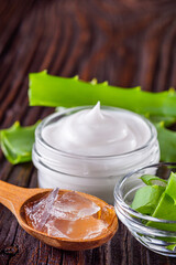 natural aloe vera cream on a dark rustic wooden background