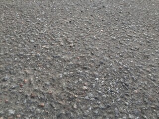 Stony asphalt texture
Asphalt section of the road close-up. There are many small multi-colored stones in the asphalt. The top layer of asphalt was rubbing off and the stones came out. Texture, backgro