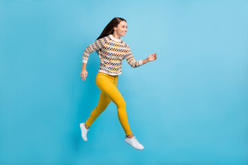 Fototapeta na wymiar Full length photo of purposeful young woman dressed ornament pullover jumping running isolated blue color background