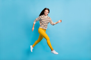 Fototapeta na wymiar Full length photo of adorable young lady wear ornament sweater running jumping isolated blue color background