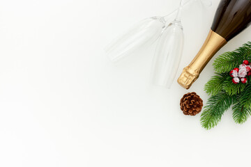 New Year decoration with champagne bottle and fir branches on white