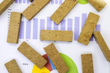 On the document with the diagram are wooden cubes with space for text. The concept for the business